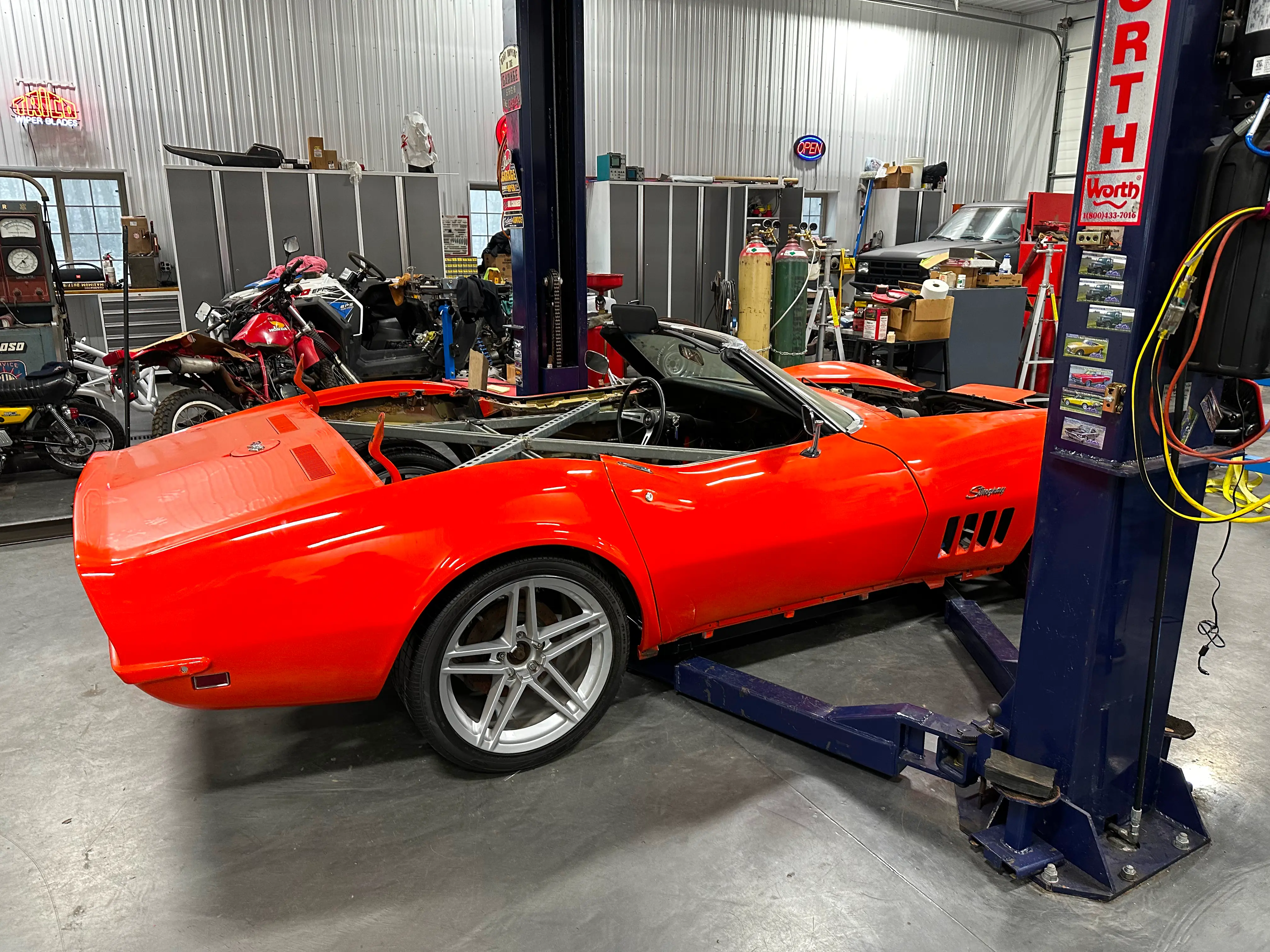 The body sitting on the new chassis on the ground